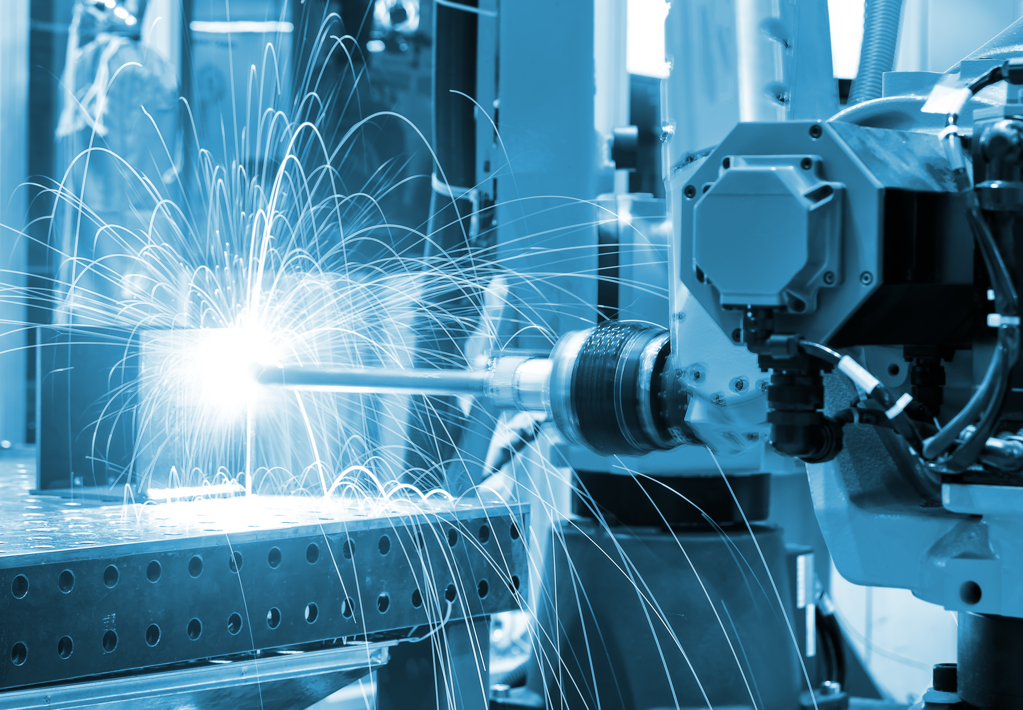 welding robot manipulator on production line close - up blue toning